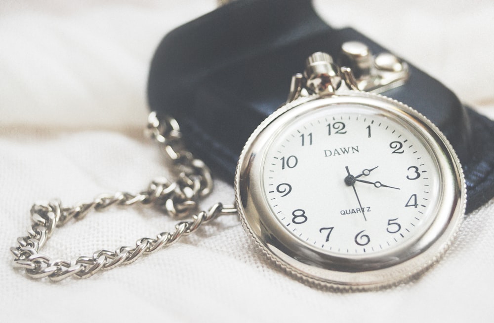 round silver-colored Dawn analog pocket watch