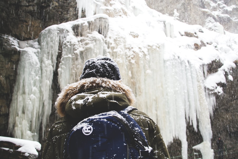 person in front of mountain