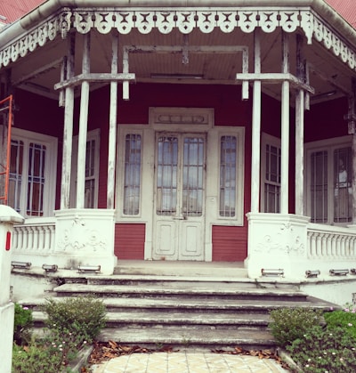 A freshly painted exterior porch with clean white trim and gray siding.