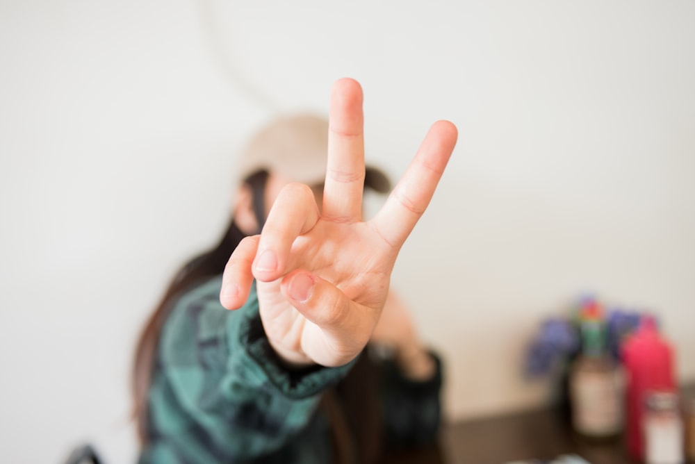 person doing peace sign