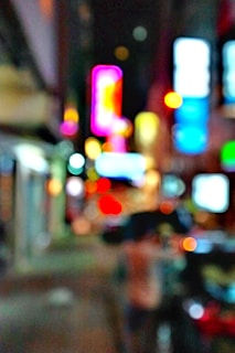 A vibrant urban street scene with graffiti art and neon lights at night.