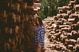 man in the middle of logs