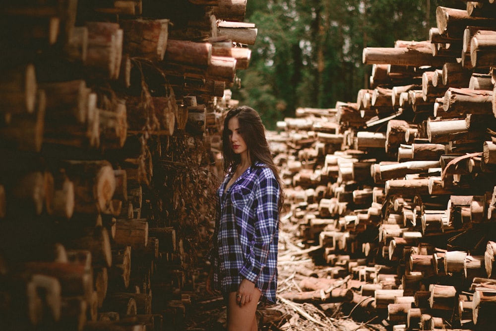 man in the middle of logs