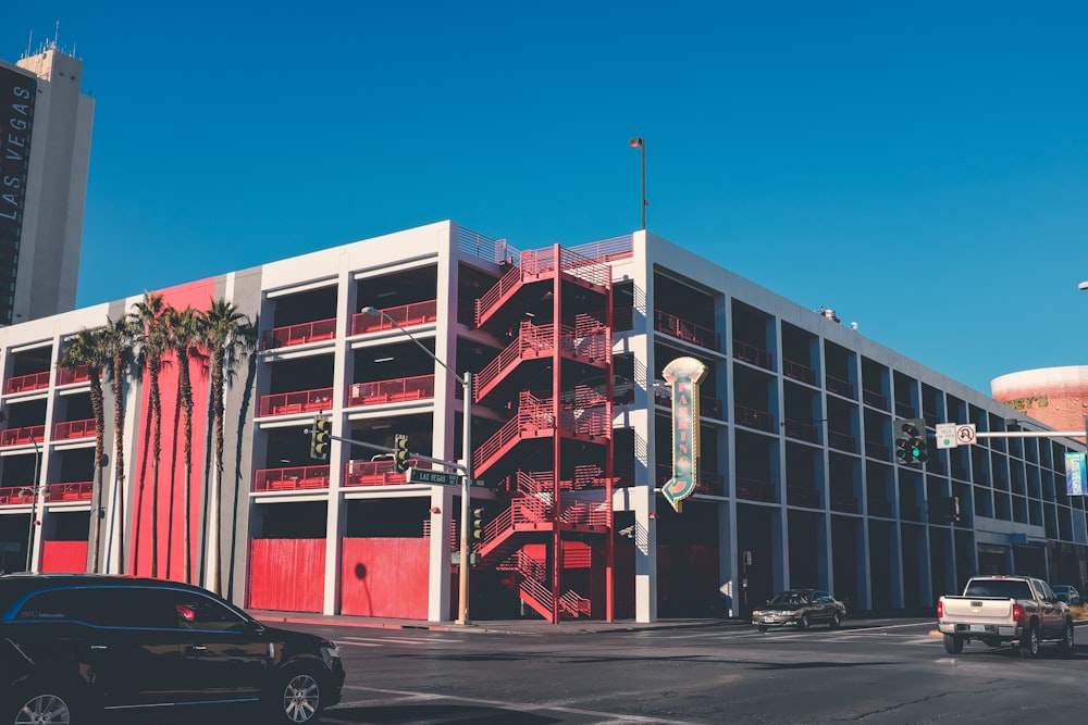 few vehicle near white and red building during daytime