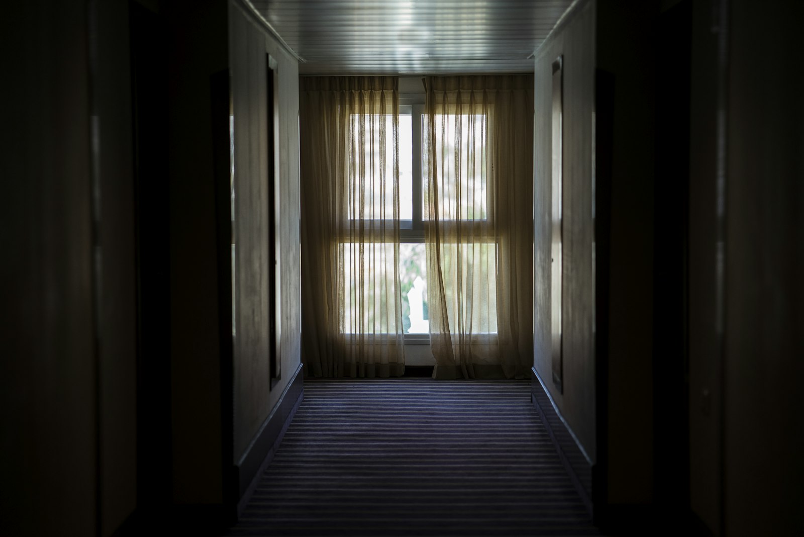 ZEISS Batis 85mm F1.8 sample photo. Hallway leading to window photography