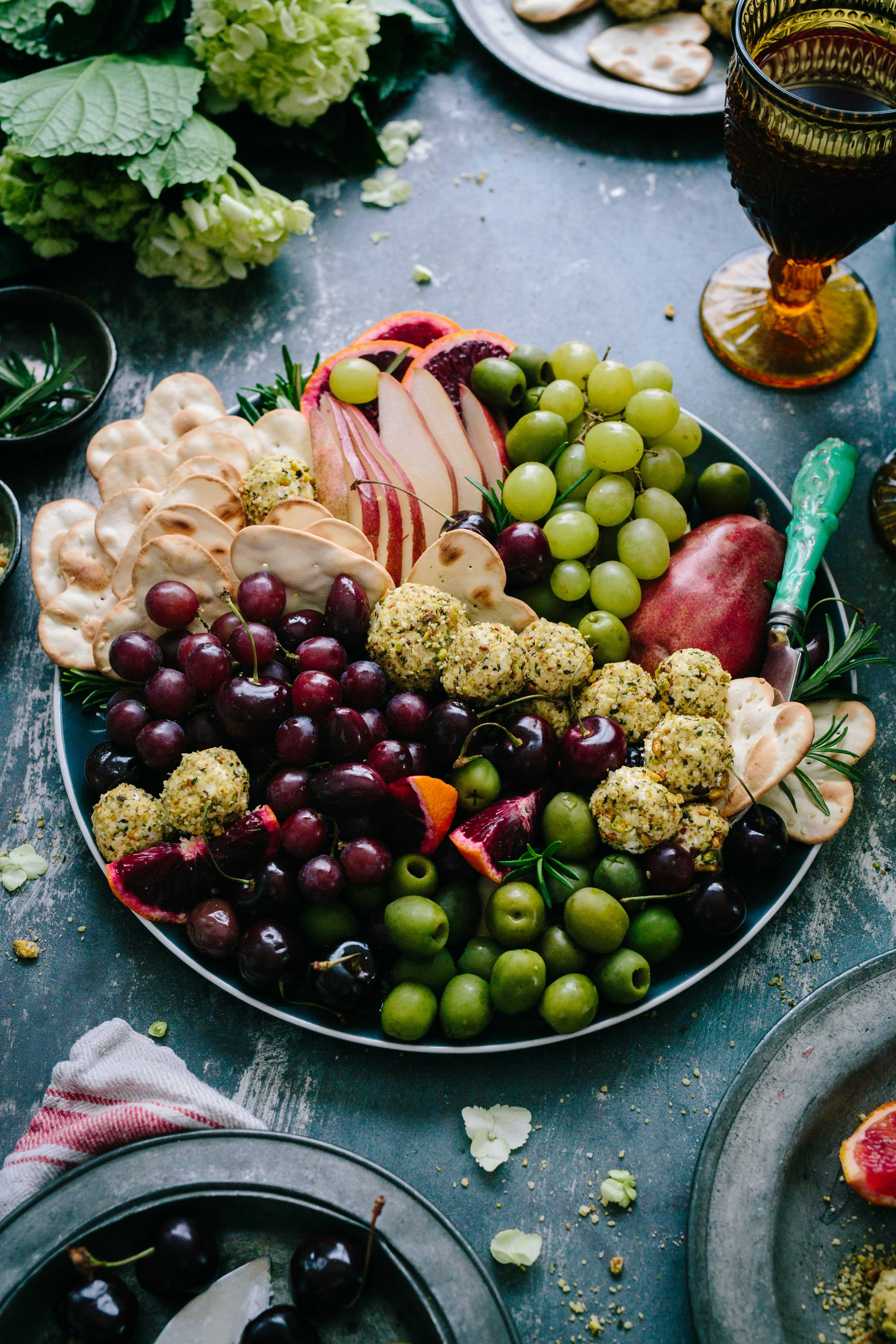 It was time to put together a party dish, and I was downright feeling lazy. Platter time! Pile on oodles of winter fruits, pretty little water crackers, pistachio-crusted goat cheese. And bazinga. Life is good.