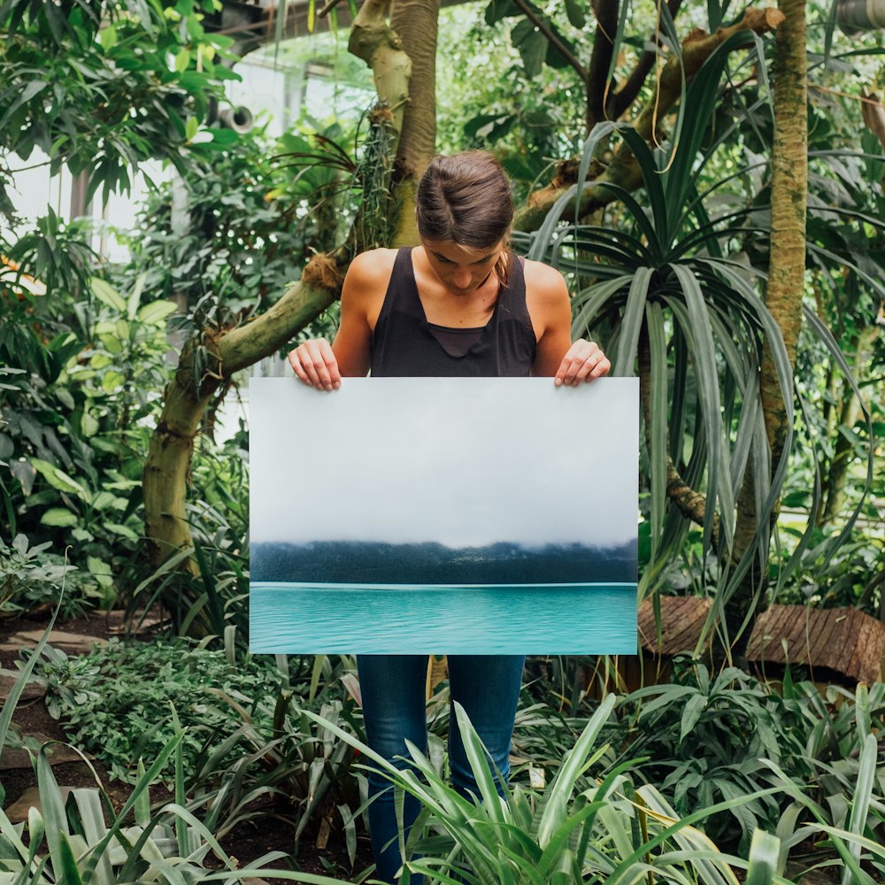 woman holding photo of tidal wave