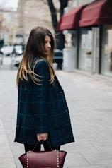 woman holding brown leather bag in bokeh photography