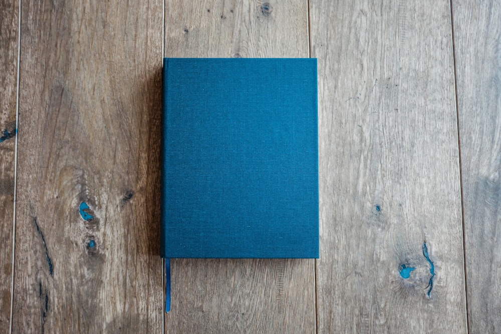 blue book on brown wooden board