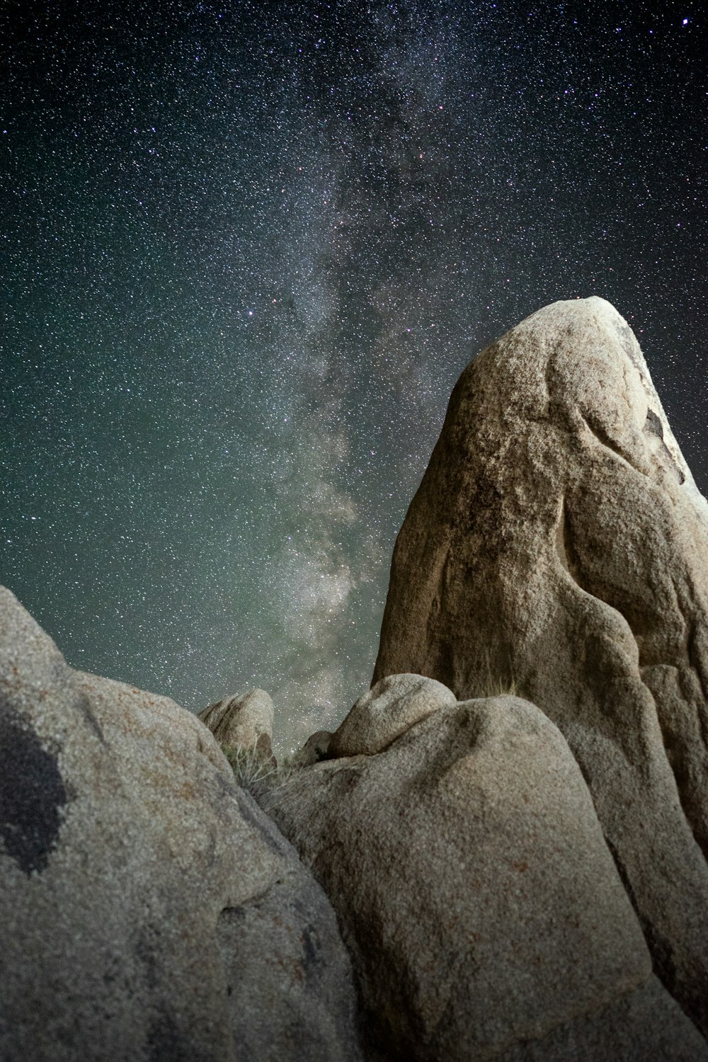 brown rock formations under starry night