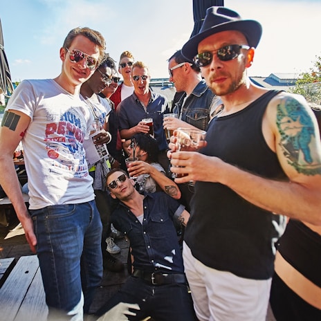 An outdoor scene with friends enjoying a sunny day in fashionable attire.