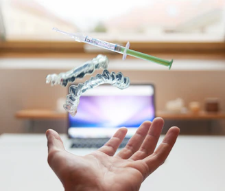 open palm with syringe floating above