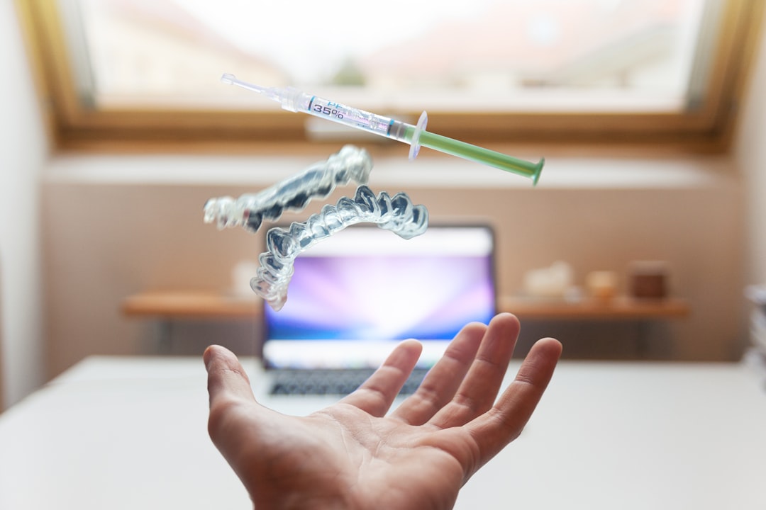 open palm with syringe floating above, dentist
