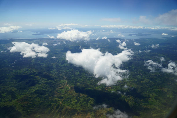 Aerial view of lush green farmland near Madurai with clear blue skies.