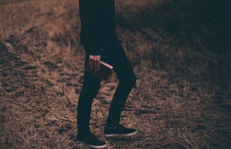 person holding book walking