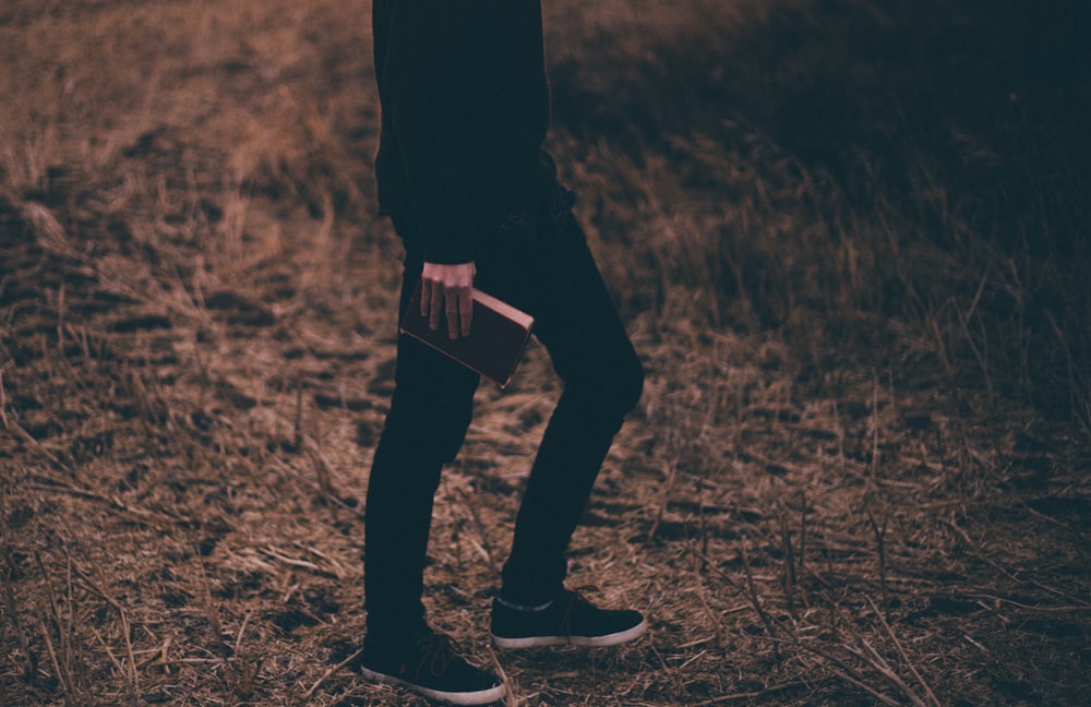 person holding book walking