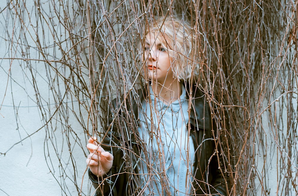 woman surrounded by bare vines