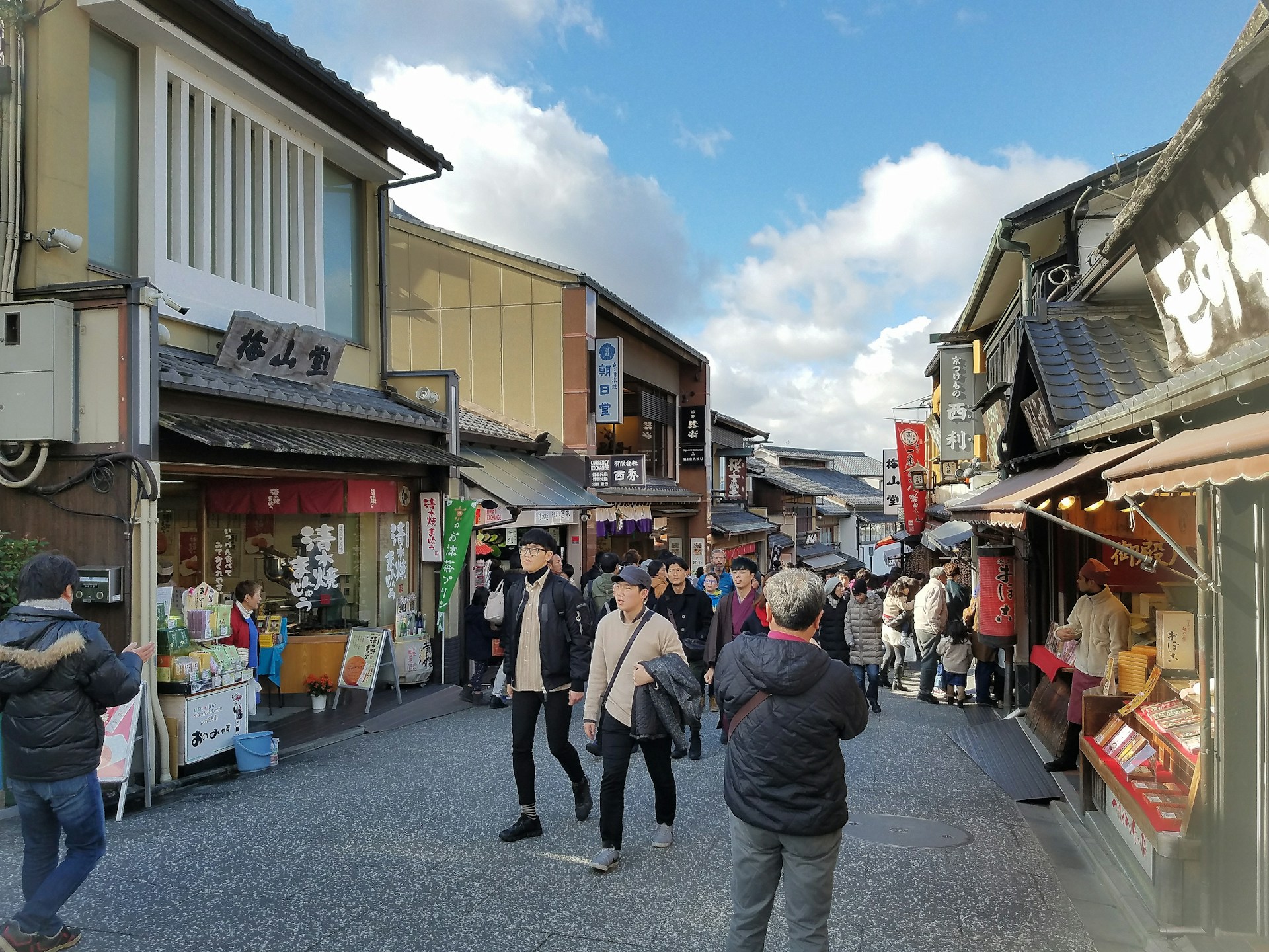 woman wearing yellow long-sleeved dress under white clouds and blue sky during daytime