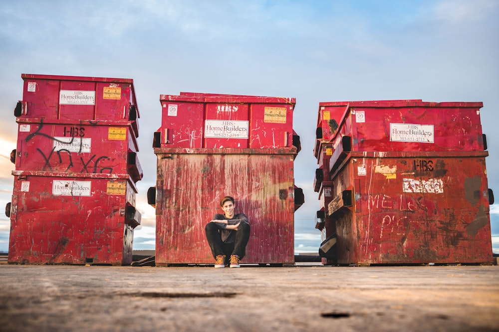 boy leaning while sitting at box