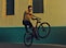 man riding bicycle doing tricks near building photography