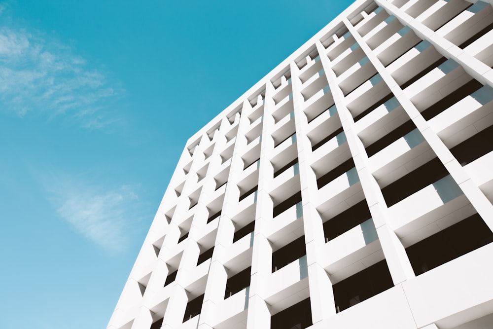 low angle photography of white building under blue sky