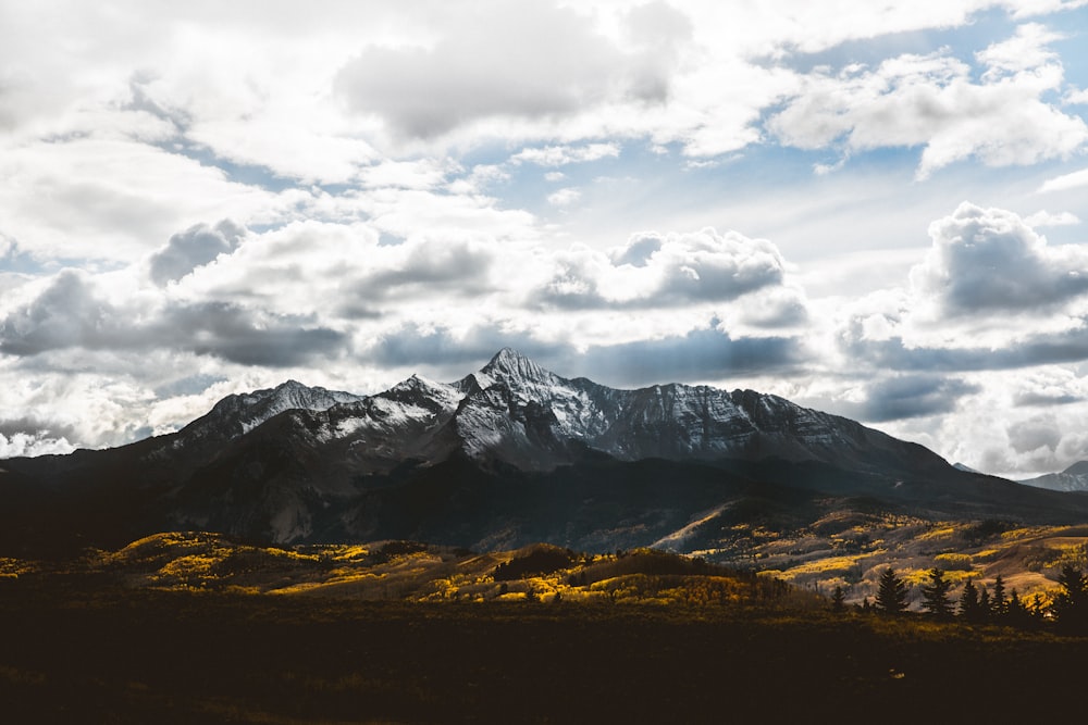 silhouette of mountain under white sky