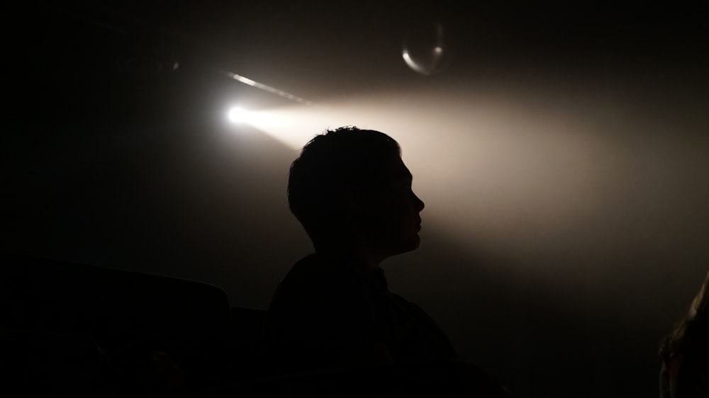 Silhouette einer Person im schwach beleuchteten Raum