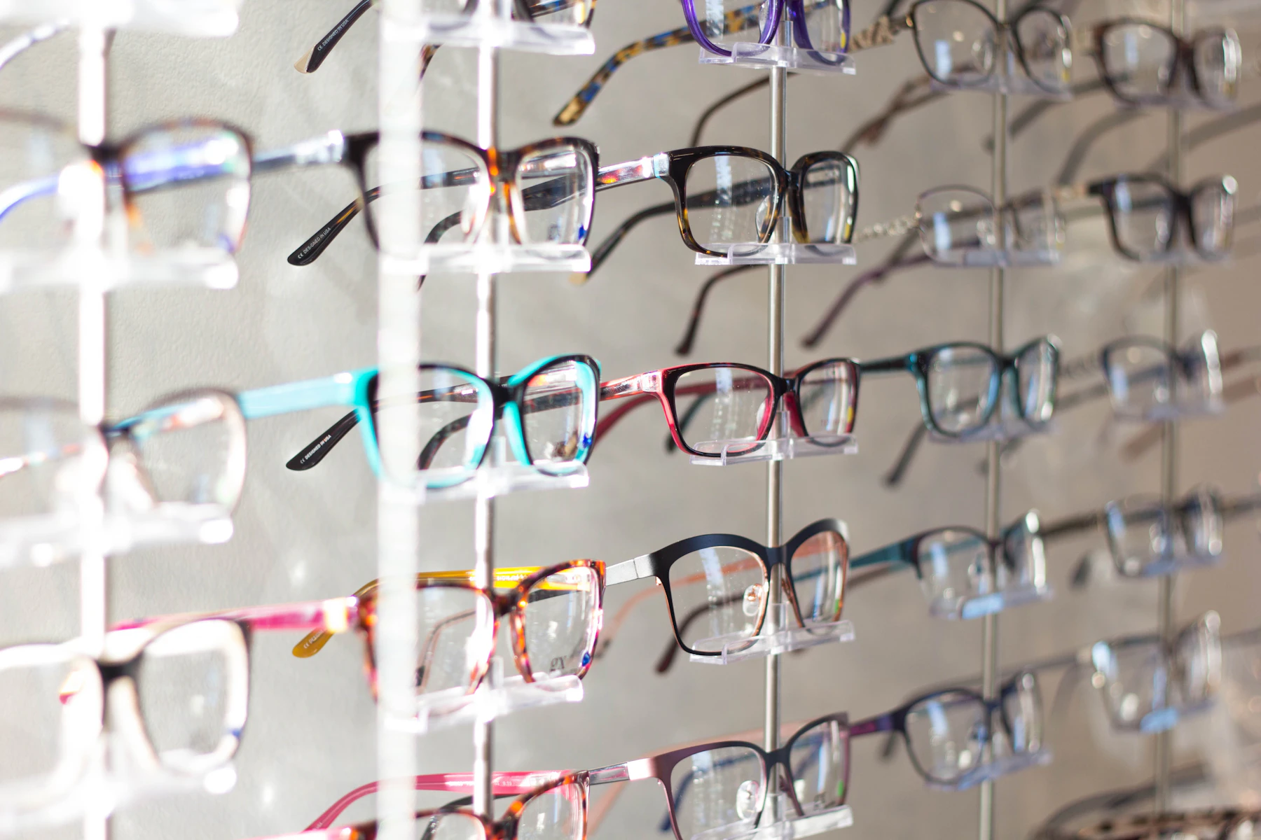Rows of colourful eyeglass frames on display