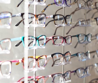 arranged assorted-color eyeglasses on rack