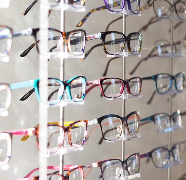 arranged assorted-color eyeglasses on rack