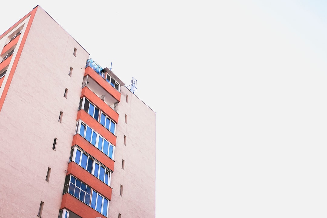 orange and blue high-rise building during clear sky