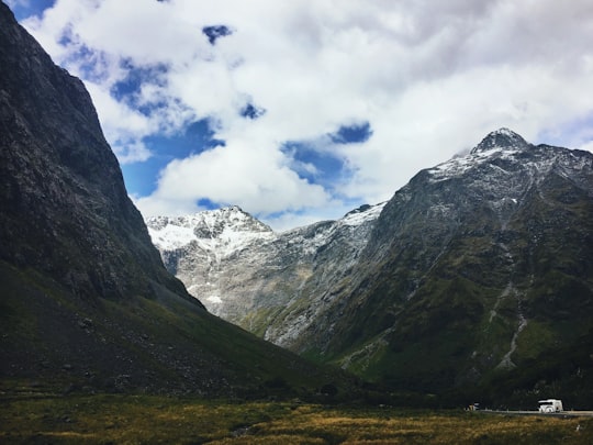 landscape photography of mountains covered by clouds during daytime in Fiordland National Park New Zealand