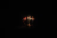 A group photo of smiling participants holding their finished candles, proud and glowing.