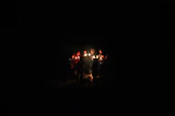 A group photo of smiling participants holding their finished candles, proud and glowing.
