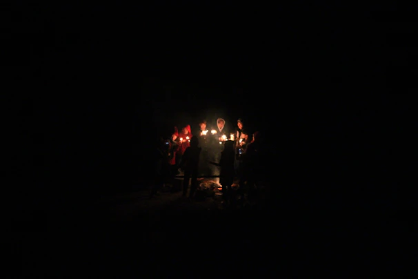 A warm group circle during a healing ceremony with candles and natural elements.