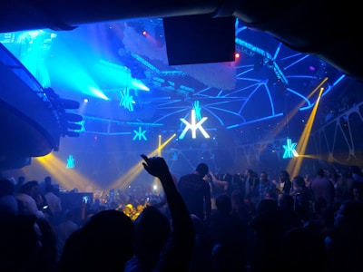 A vibrant nightclub scene with colorful lights and dancing people.