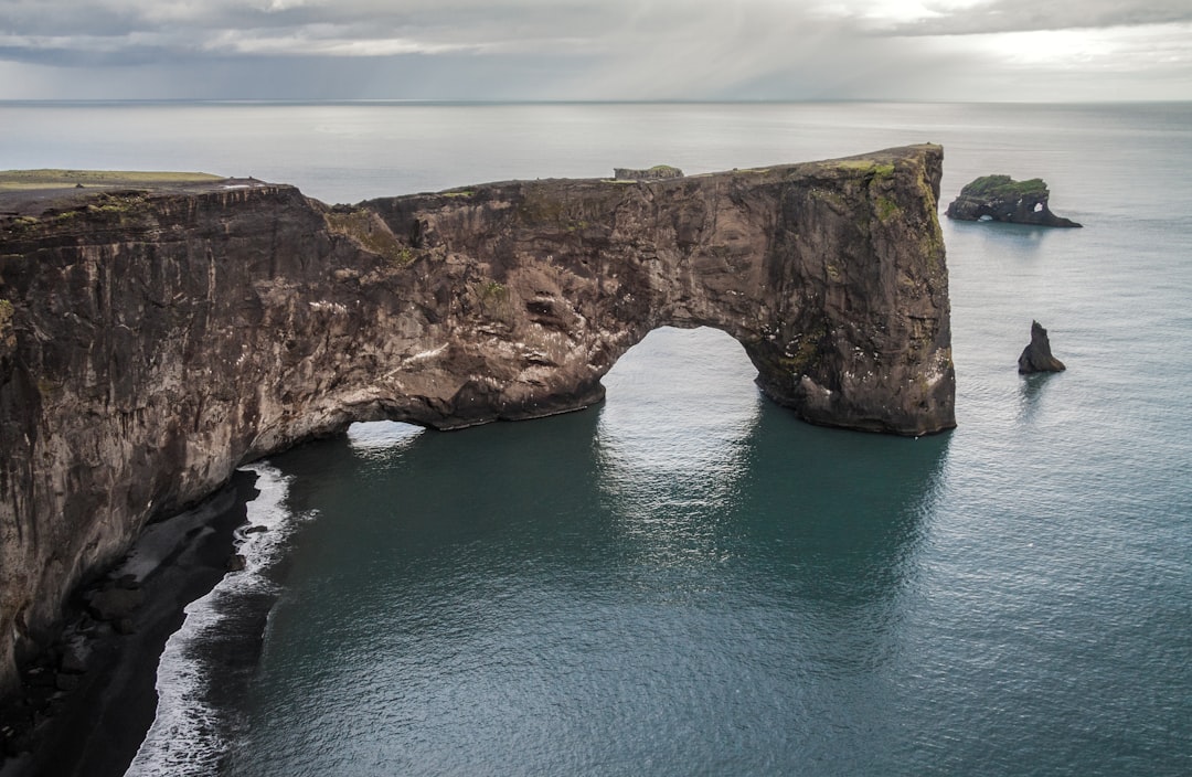 Natural arch photo spot Vik Dyrhólaey Light