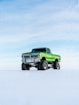green off-road vehicle on snow during winter season