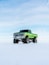 green off-road vehicle on snow during winter season