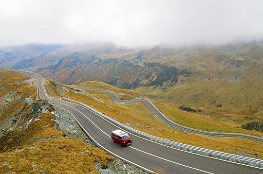 aerial photography of white and red vehicle on road during daytime in DN67C Romania