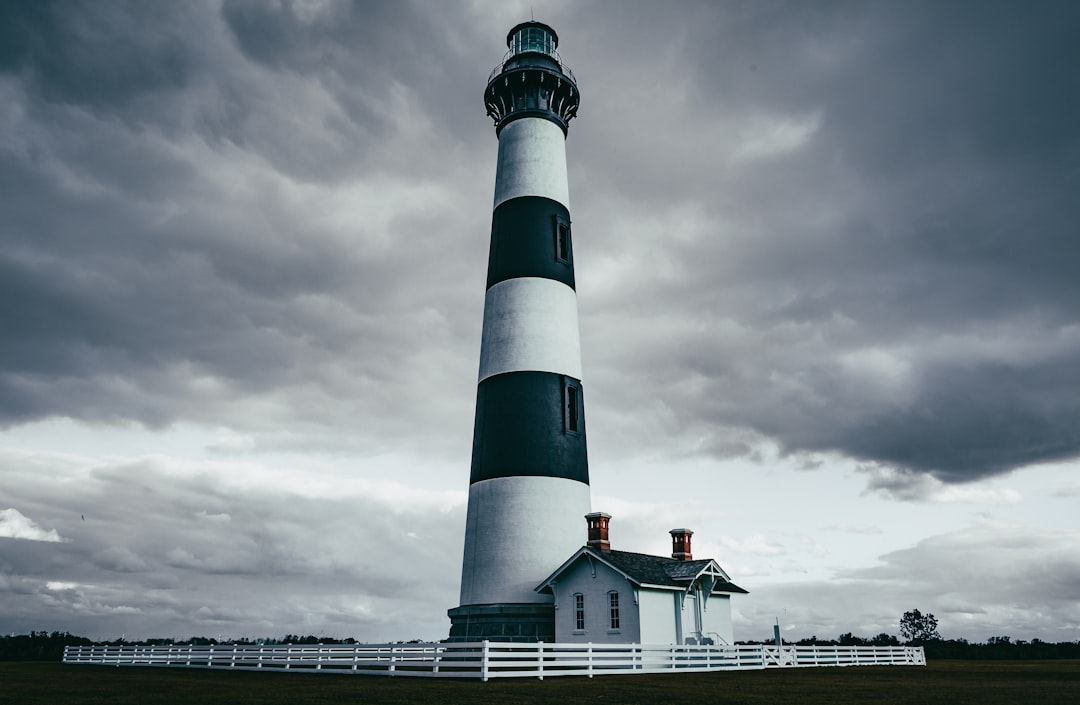 grayscale photography of light house, Lighthouse on a cloudy day