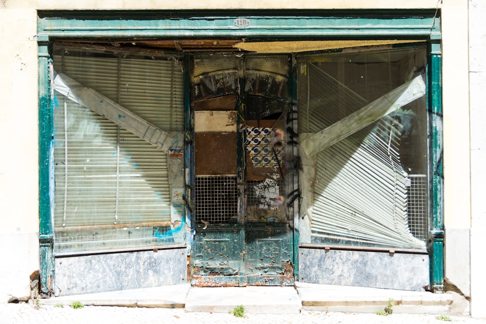 abandoned building with white venetian blinds on window