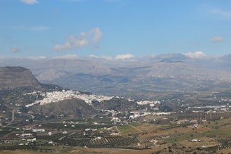 A panoramic view of the white villages (pueblos blancos) nestled in the green hills of Andalusia.