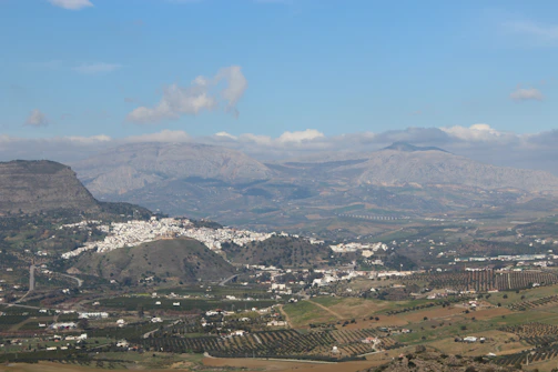 A drone shot revealing the winding hiking paths cutting through white Andalusian villages.