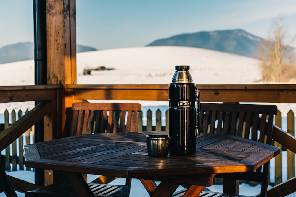 black bottle on brown wooden table