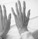 persons left hand on white textile