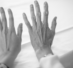 persons left hand on white textile