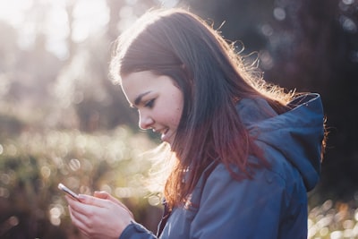 woman holding phone smiling