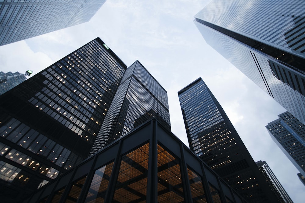 Low-angle photo of city high rise buildings during daytime.