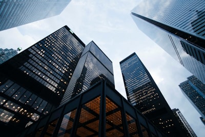 low angle photo of city high rise buildings during daytime business teams background